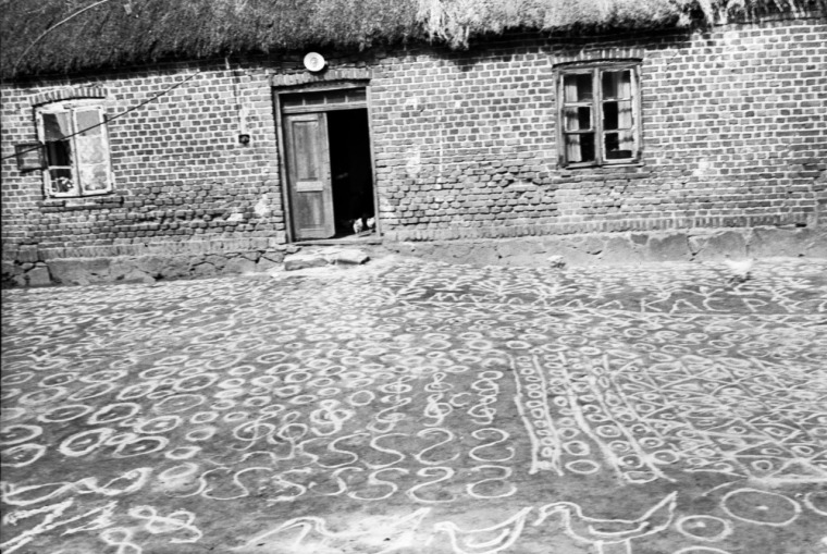 Drawing protective symbols with sand in Poland